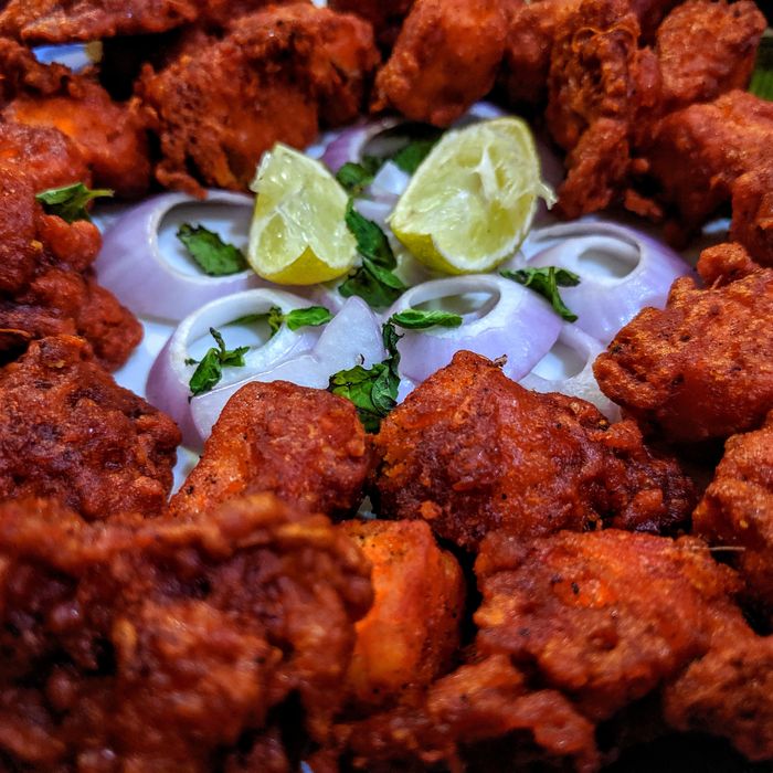 Chicken 65 — spicy deep-fried chicken garnished with curry leaves and lime