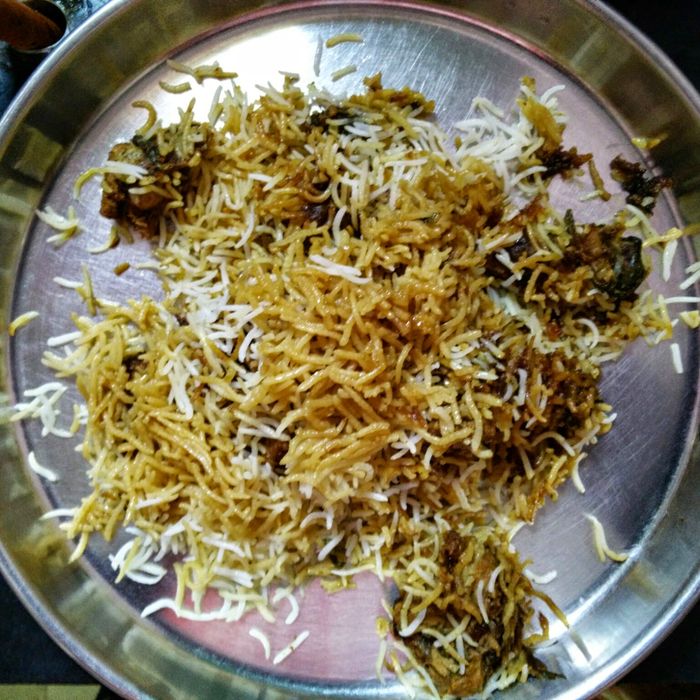 Hyderabadi Mutton Dum Biryani served on a steel thali