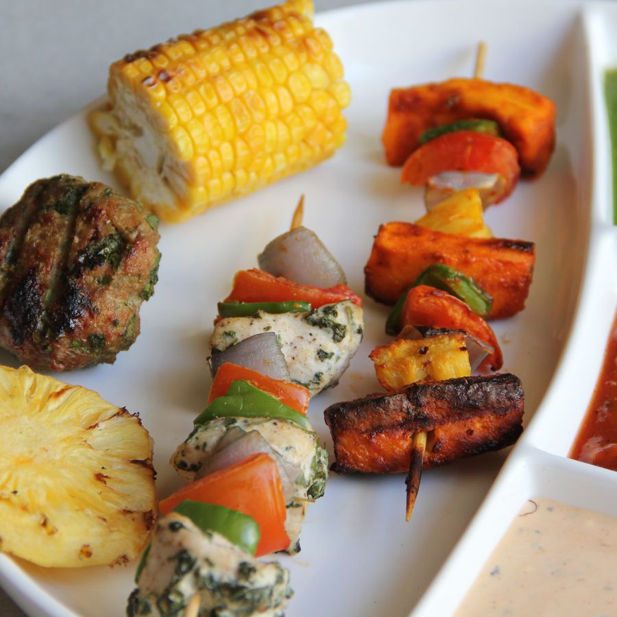Assorted tandoor-grilled kebab platter with vegetables